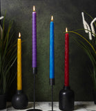 Four 12" coloured beeswax tapers burning