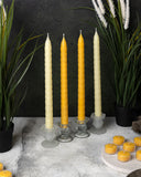 Four yellow and ivory beeswax tapers