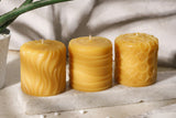three pure beeswax pillars in the sun