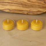 Three pure beeswax tealight candles in clear cups